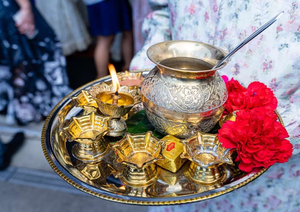 Puja thali with diyas, kalash and marigolds