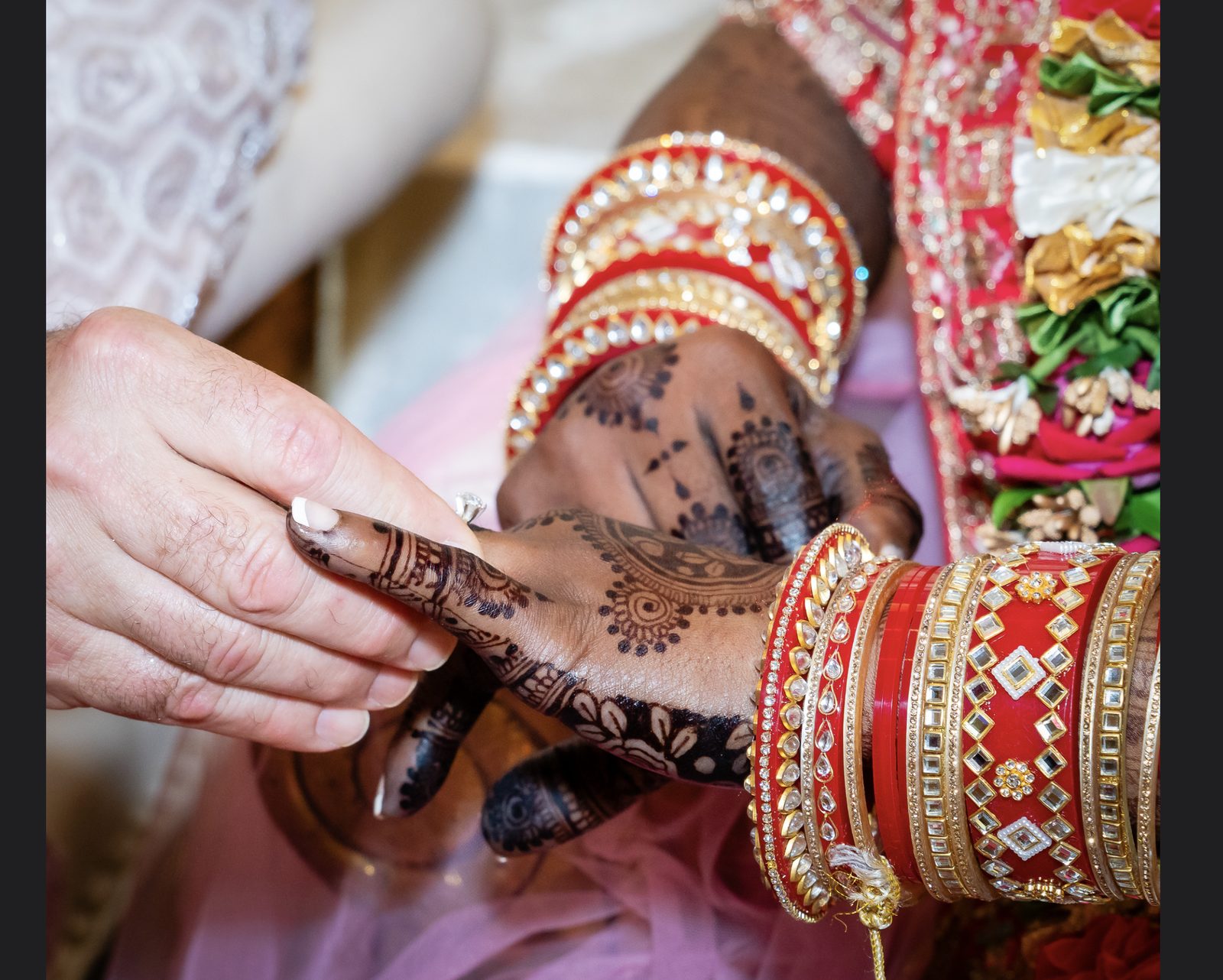 Ring ceremony — henna-adorned hands and bridal bangles