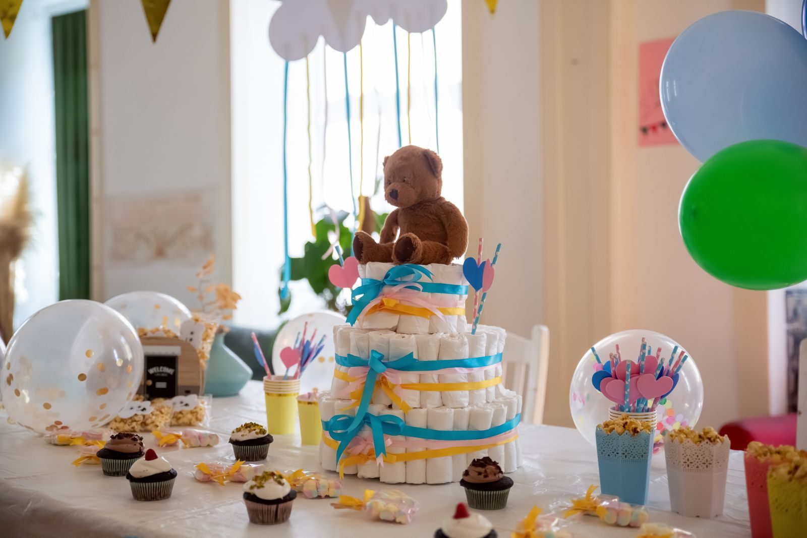 Baby shower dessert table with balloons and treats